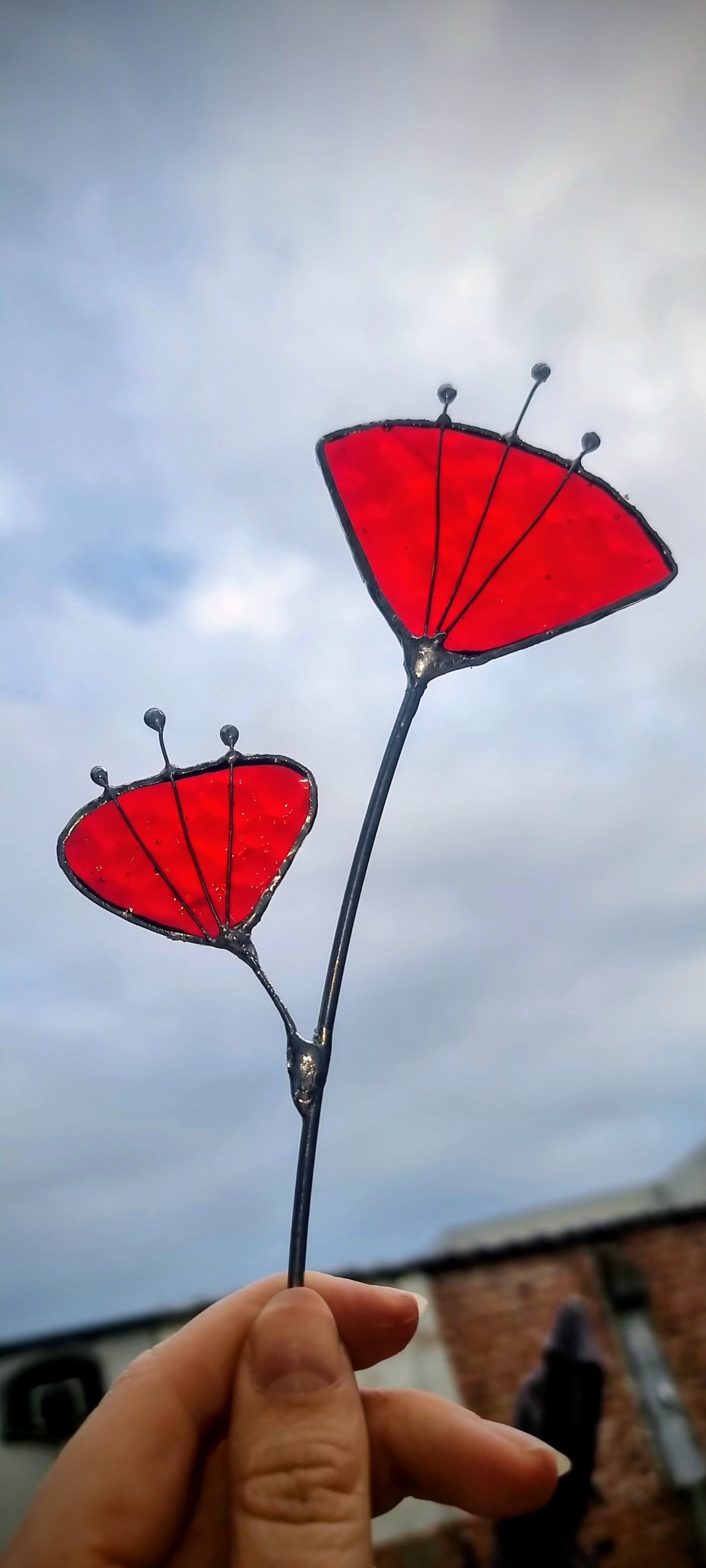 Handgemaakte glas in lood bloemen met rode blaadjes, buiten gehouden bij Maak Atelier Antwerpen